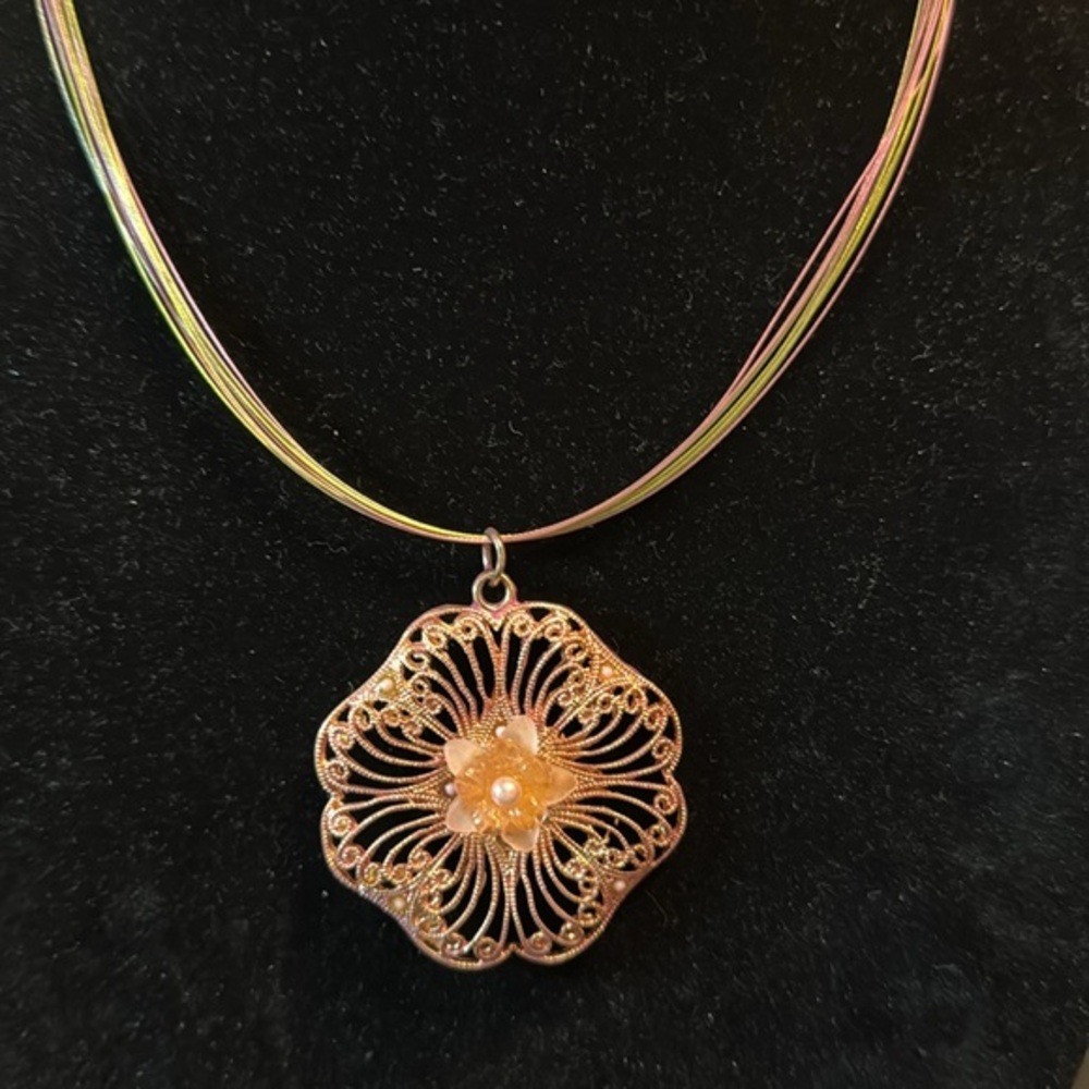 Filigree rose tone acrylic floral pendant on illusion multi-hued wire chain